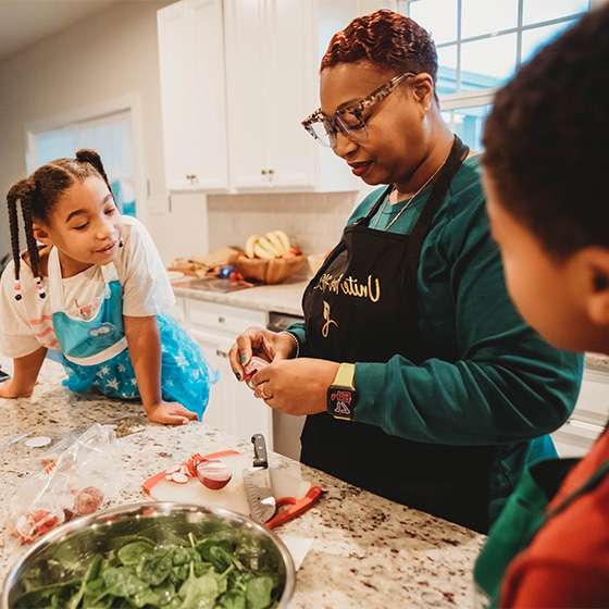 Studio161-Unite4HER-Lakia-42 Unite for HER wellness program member cooking in kitchen