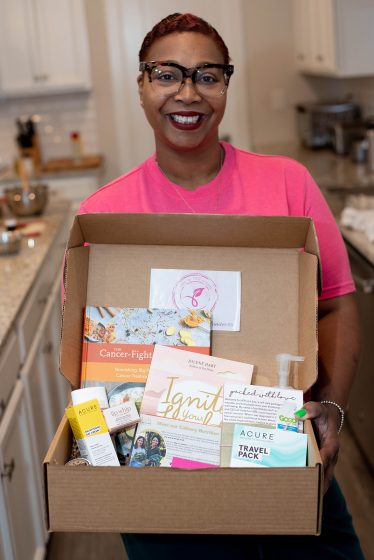 Unite for HER Unite for HER wellness program member holding care box